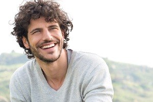man with curly hair smiling