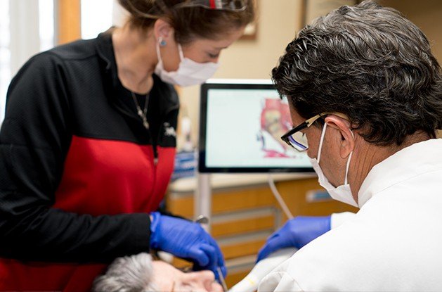 Dentist using intraoral camera
