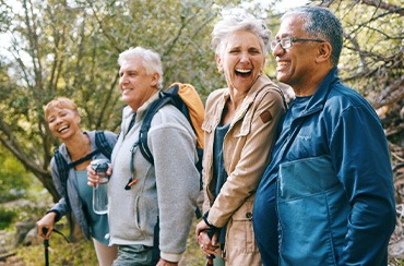 Healthy senior friends hiking outdoors