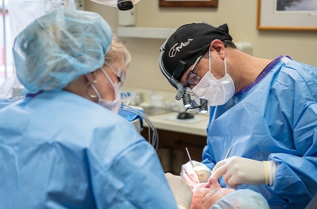 Dentist wearing mask and hair nets