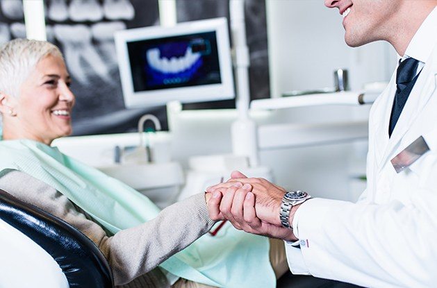 dentist shaking woman's hand