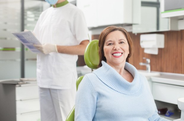 Woman smiling in dental chair after root canal therapy in East Longmeadow & Northampton 