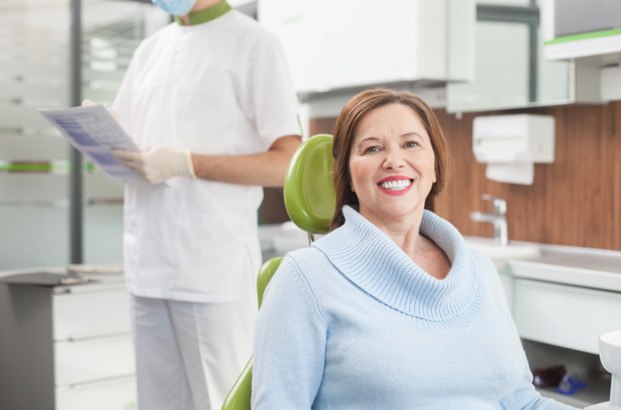 Woman smiling in dental chair after root canal therapy in East Longmeadow & Northampton