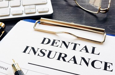 Dental insurance form on clipboard on desk 