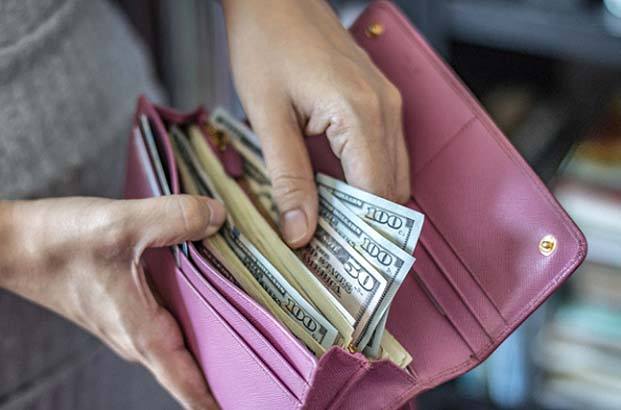 Wallet of money for cost of cosmetic dentistry in Northampton