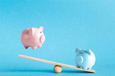 Piggy banks on balance scale