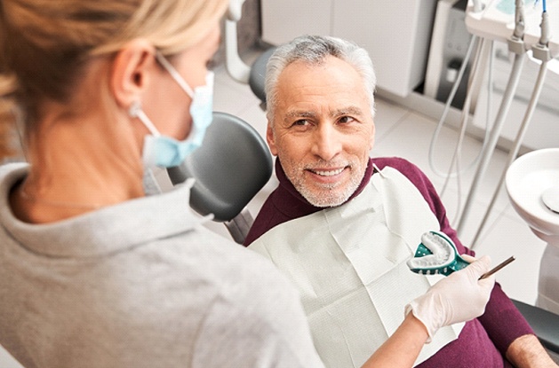 dentist explaining dentures to patient