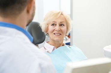 patient smiling while talking to dentist