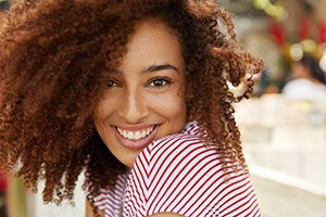 woman in striped shirt smiling