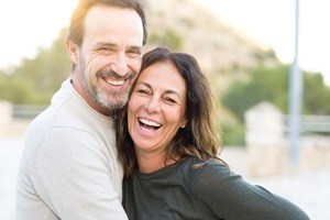 couple laughing together/></div>
	<p>
		Once we have decided that a dental bridge is right for you, we’ll schedule your treatment. First, a small portion of enamel will need to be removed from the 2 teeth surrounding the gap to accommodate the crowns. These dental crowns play an important role as they support the dental bridge. Next, we will bond your dental bridge to your smile, seamlessly replacing your missing teeth while restoring your natural appearance and function.</p>
	<h2>
		The Benefits of Dental Bridges</h2>
<div class=