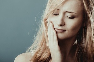 blonde woman with severe dental pain