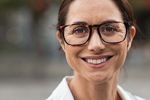 woman with glasses smiling