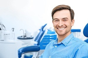 man in jean shirt smiling