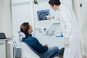 man looking at x-ray while in chair