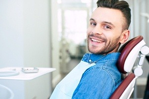 man in jean jacket smiling