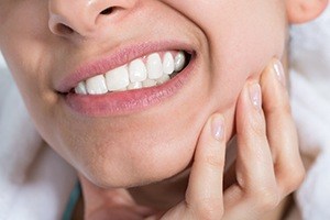 woman gritting one side of mouth