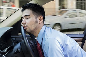 man asleep in car