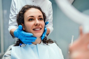 dentist holding woman's head