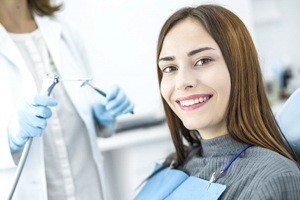 woman in green sweater smiling