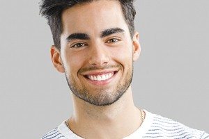 man in striped shirt smiling