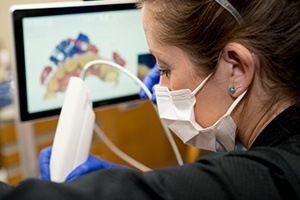 dentist using impression system on patient