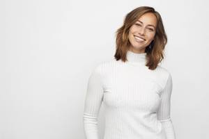 woman in white sweater smiling
