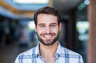 Smiling man in patterned shirt with dental implants in Northampton, MA