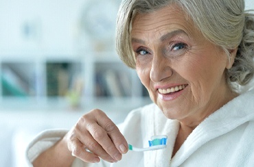 Woman brushing teeth in East Longmeadow & Northampton