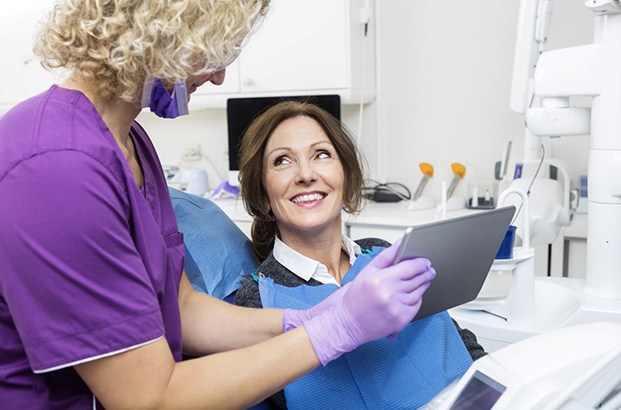 a patient being shown a picture of dental implants
