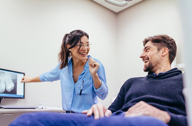 Implant dentist in Northampton talking to patient about X-rays