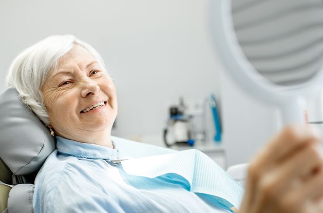 woman checking smile in mirror