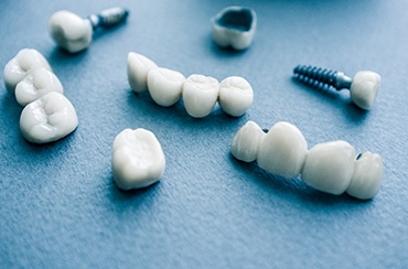 Different types of dental implants on blue background