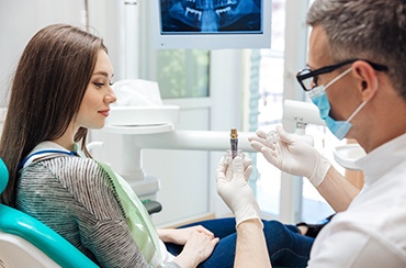 Northampton implant dentist showing patient model of dental implant