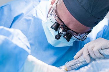 Closeup of dentist performing dental implant surgery