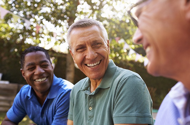 Men with dental implants in East Longmeadow & Northampton smiling