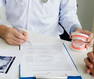 Closeup of insurance paperwork for the cost of Invisalign in East Longmeadow