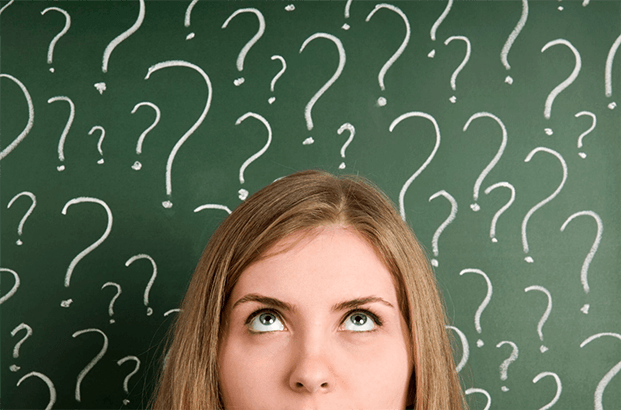 Woman’s face in front of chalk board with question marks