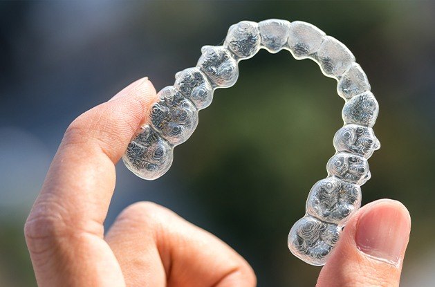 hand holding top invisalign tray