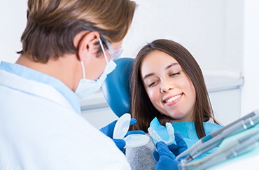 A dentist showing a mouthguard to one of his patients