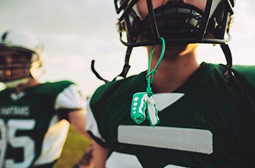 A young American football player with his mouthguard out