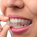 Patient placing Invisalign tray