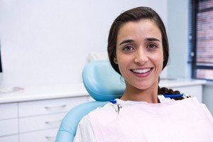 woman smiling in light blue chair