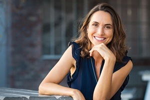 woman in black dress smiling