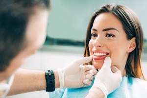 dentist pulling patients lip down