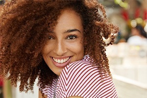 woman smiling with curly red hair