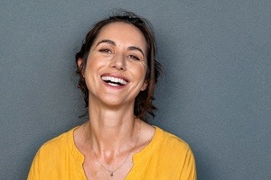 woman in yellow shirt laughing