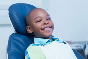 young boy smiling after teeth cleaning