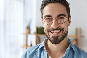 man with circle glasses smiling