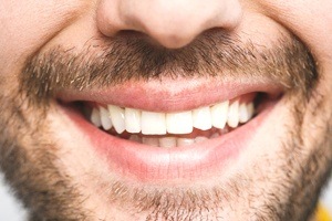 close up of man with beard smile