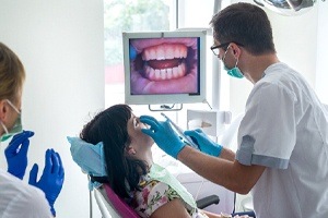 woman with intraoral camera showing inside mouth